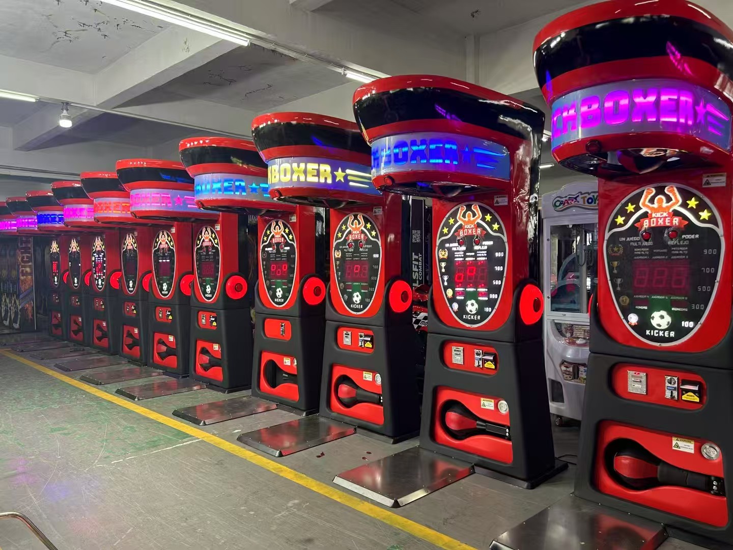 Row of AMA Amusement boxer arcade machines in factory