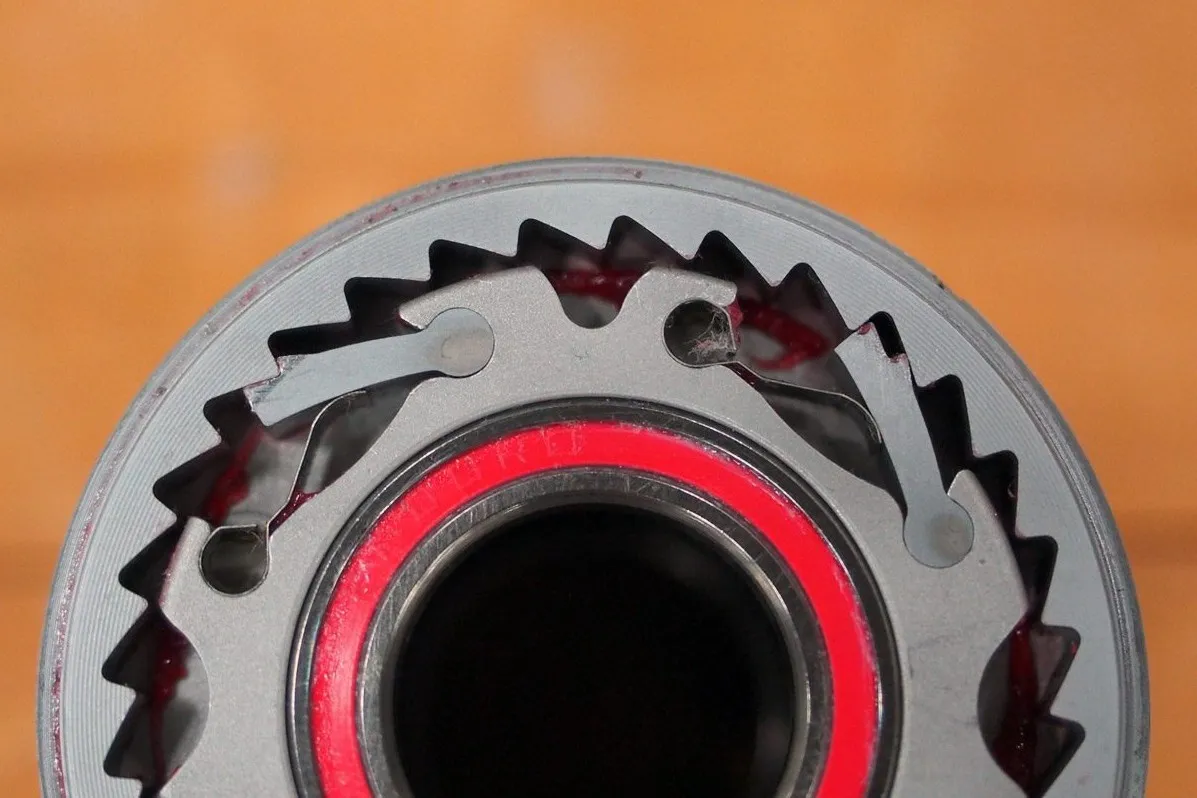 Internal structure of a bicycle hub showing pawls and ratchets