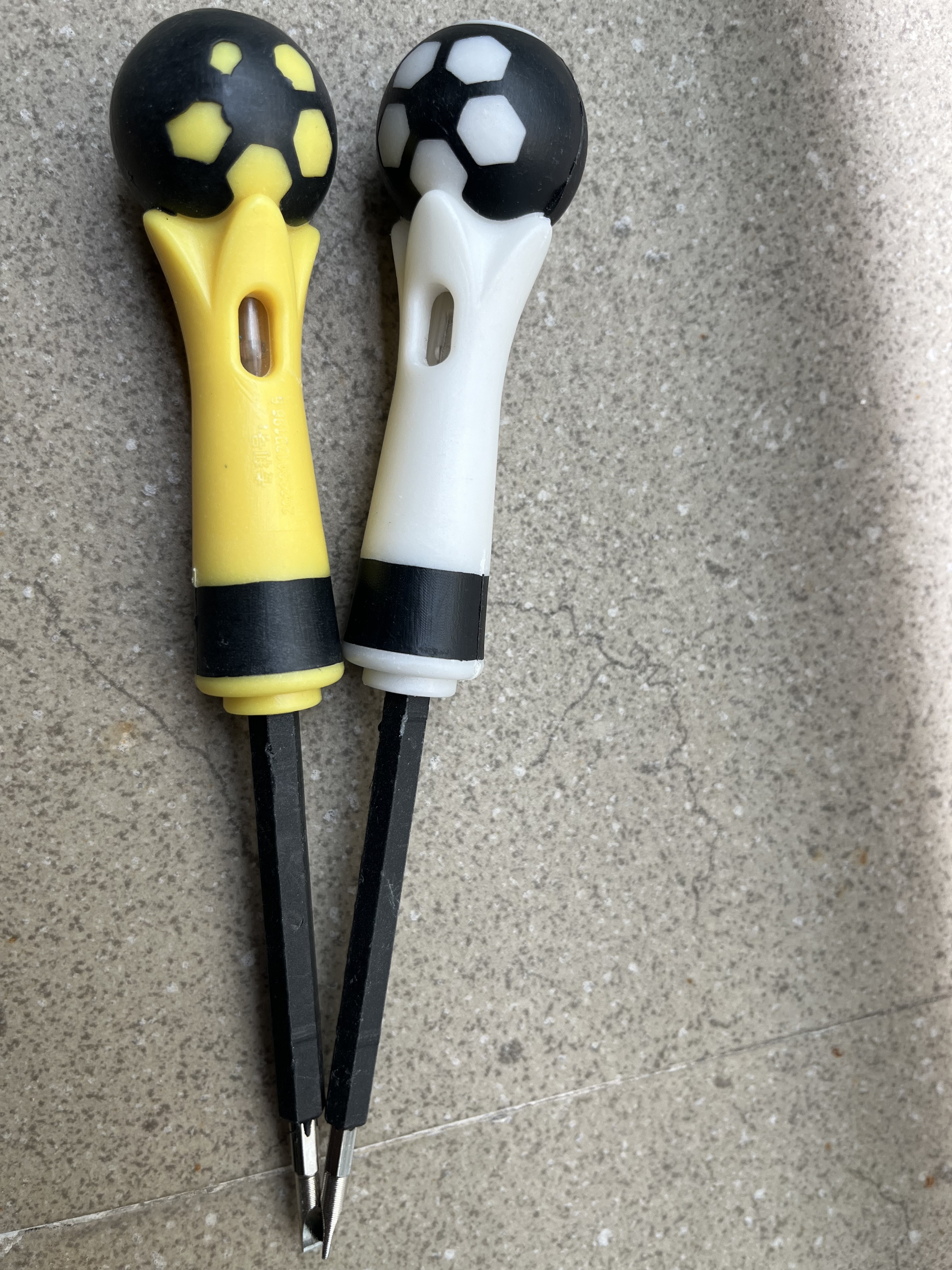 A ball-handled safety electrical test pen with a neon lamp and screwdriver function.