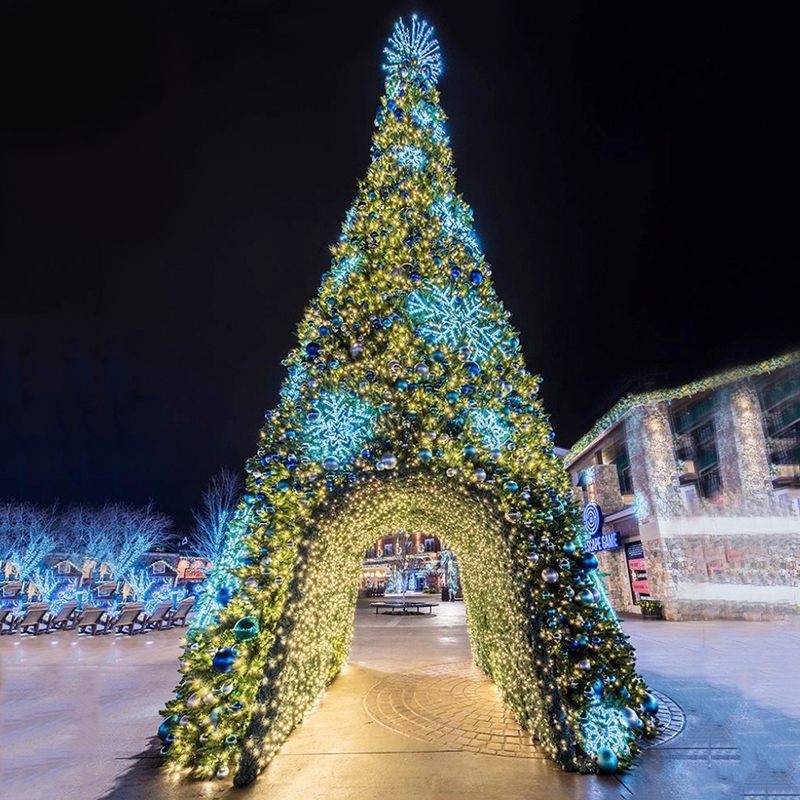 Magnificent illuminated giant Christmas tower tree in a festive winter setting