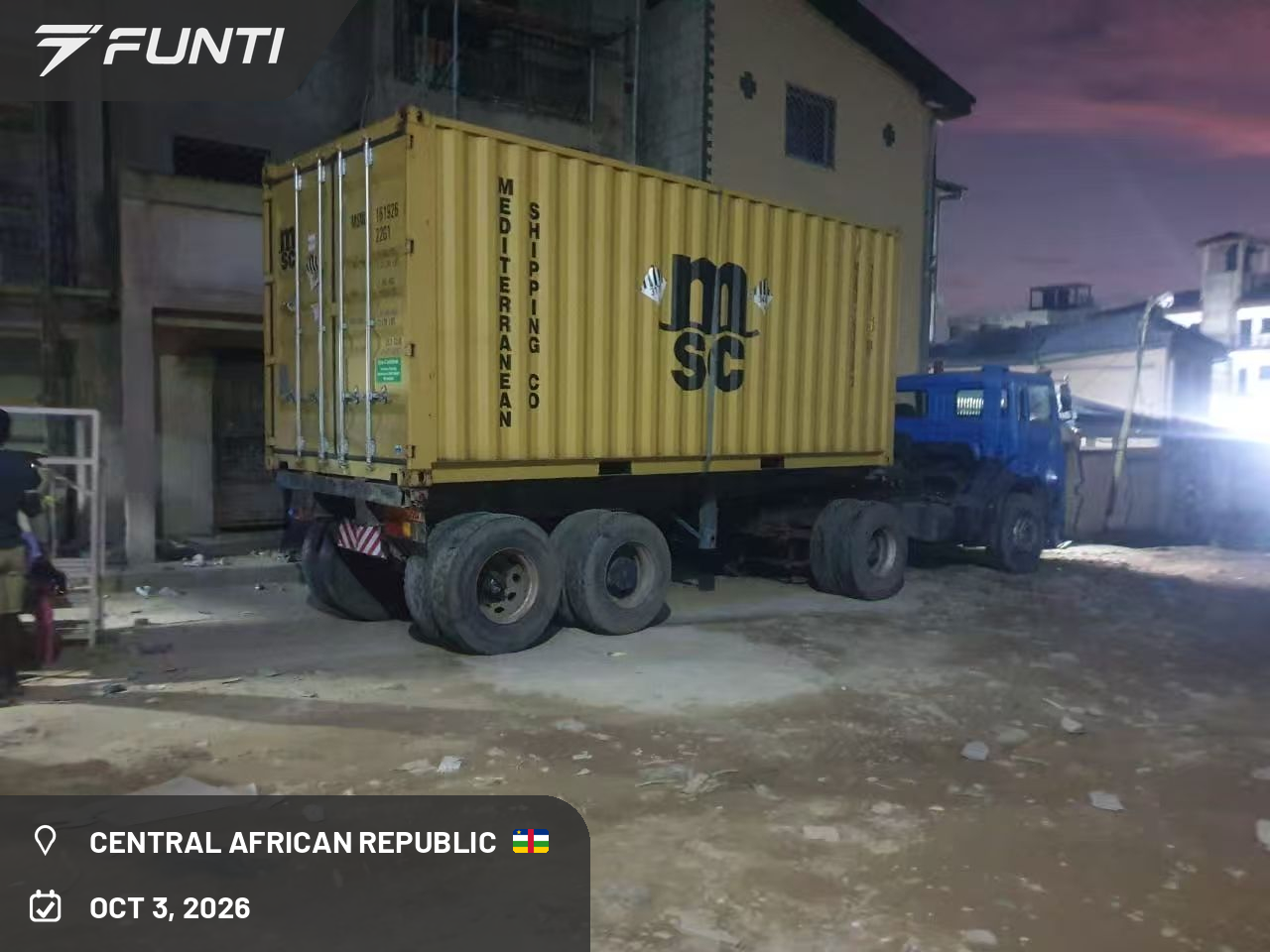 The shipping container carrying the FUNTI NITRO electric motorcycle shipment on site at night during unloading, Central Africa, October 2026