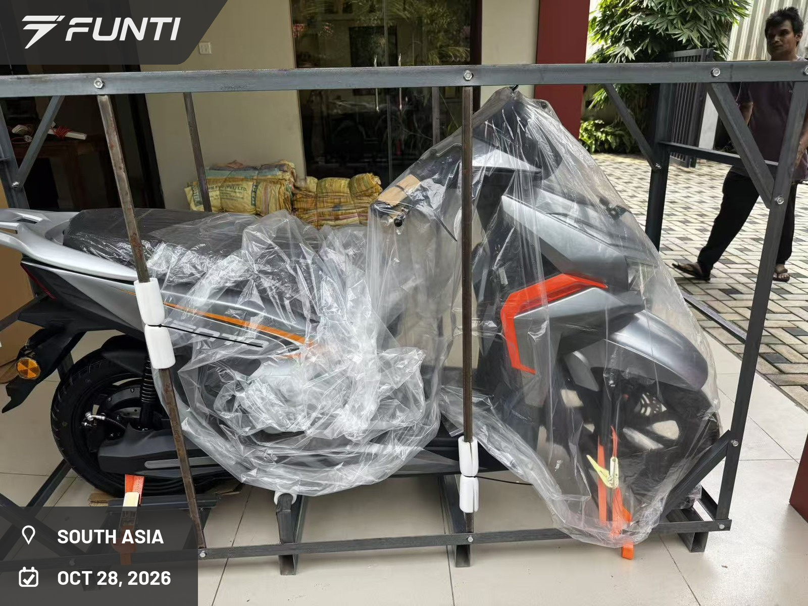 FUNTI VENTO electric motorcycle in its steel shipping frame, unpacked at the customer's premises