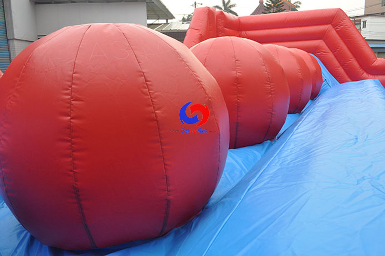 interactive games inflatable obstacle course 4 huge red balls Leaps N Bounds Big Baller wipeout for kids adults