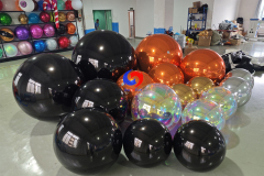 giant black shiny spheres giant orange silver gold iridescent shiny ballons