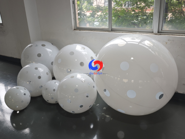 Clean white polka dot giant inflatable pickleballs in assorted mixed sizes, designed for all USA Pickleball events!