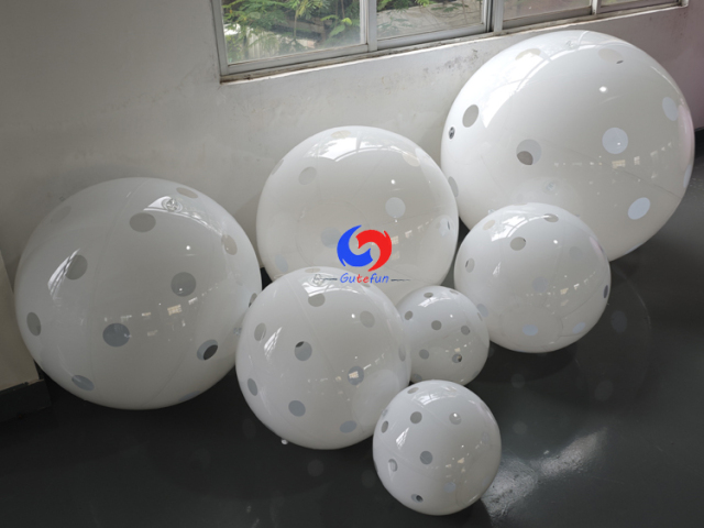 Clean white polka dot giant inflatable pickleballs in assorted mixed sizes, designed for all USA Pickleball events!