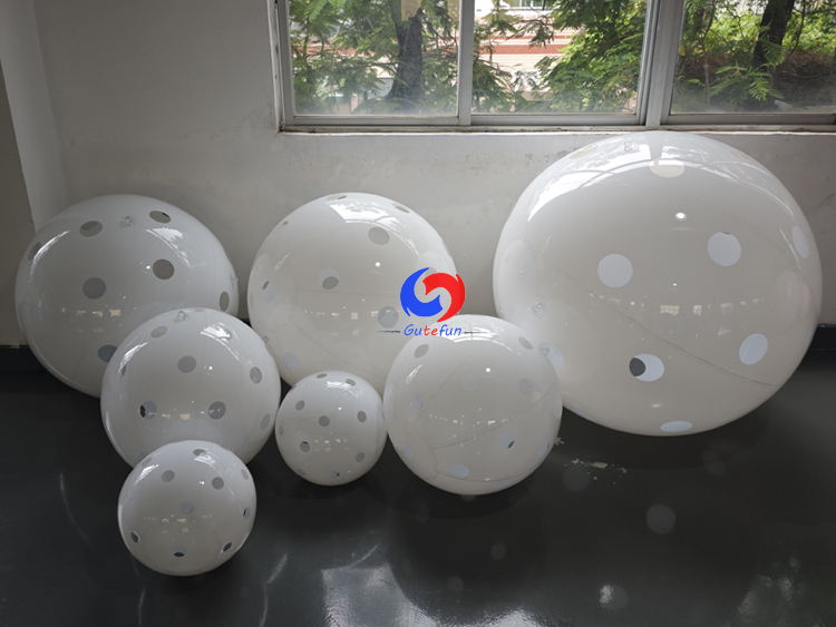 Clean white polka dot giant inflatable pickleballs in assorted mixed sizes, designed for all USA Pickleball events!