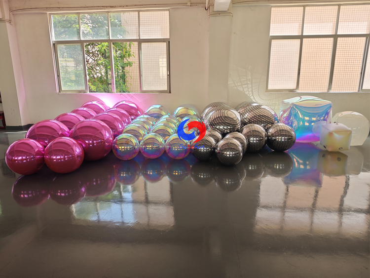 Full range inflatable event decor: metallic mirror balls, holographic iridescent spheres, disco grid balls & iridescent cubes