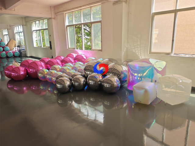 Full range inflatable event decor: metallic mirror balls, holographic iridescent spheres, disco grid balls & iridescent cubes