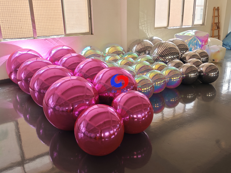 Full range inflatable event decor: metallic mirror balls, holographic iridescent spheres, disco grid balls & iridescent cubes