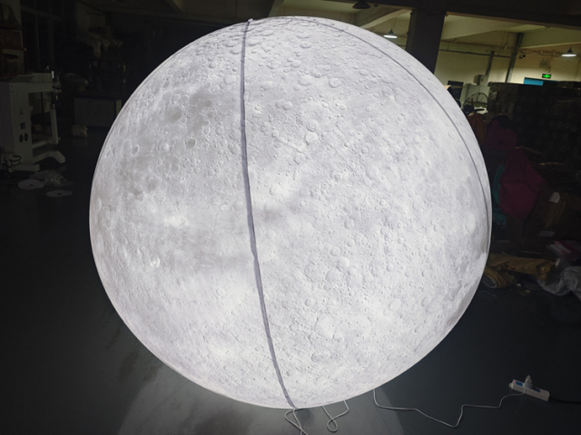 Giant LED inflatable moon ball realistic crater texture glowing white sphere for commercial event mall wedding installation