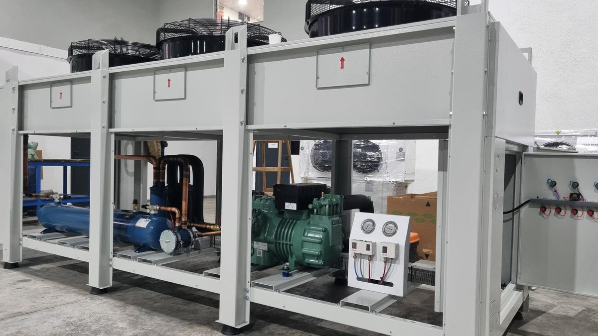 Plant room condensing unit with two fin-and-tube condensers above a semi-hermetic compressor, receiver and copper pipework