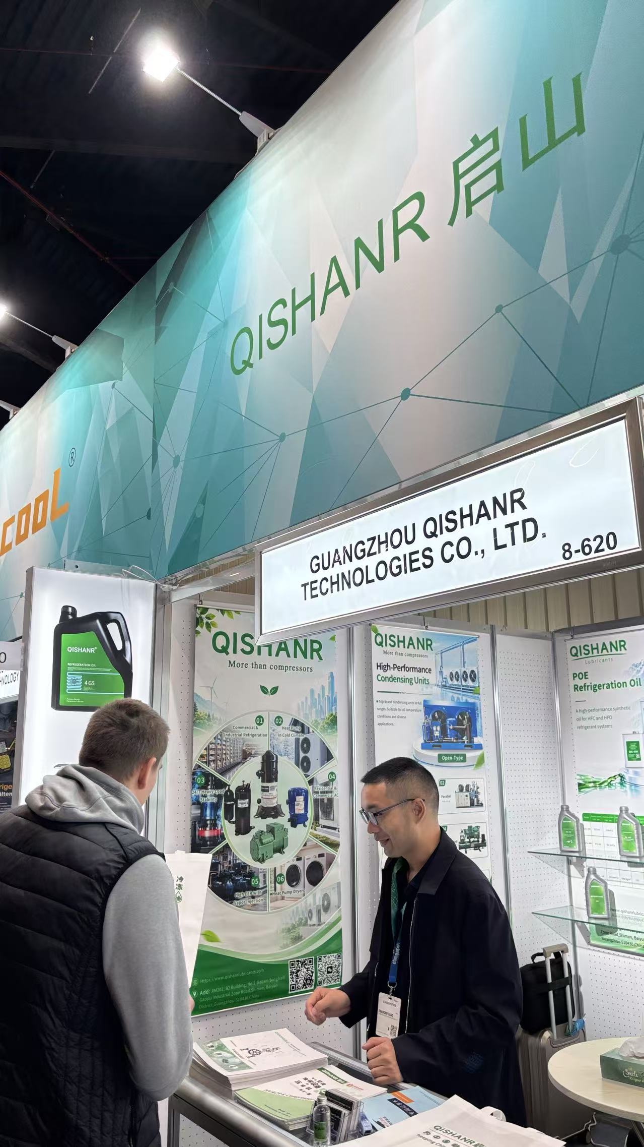 Qishanr team member introducing product brochures to a visitor
