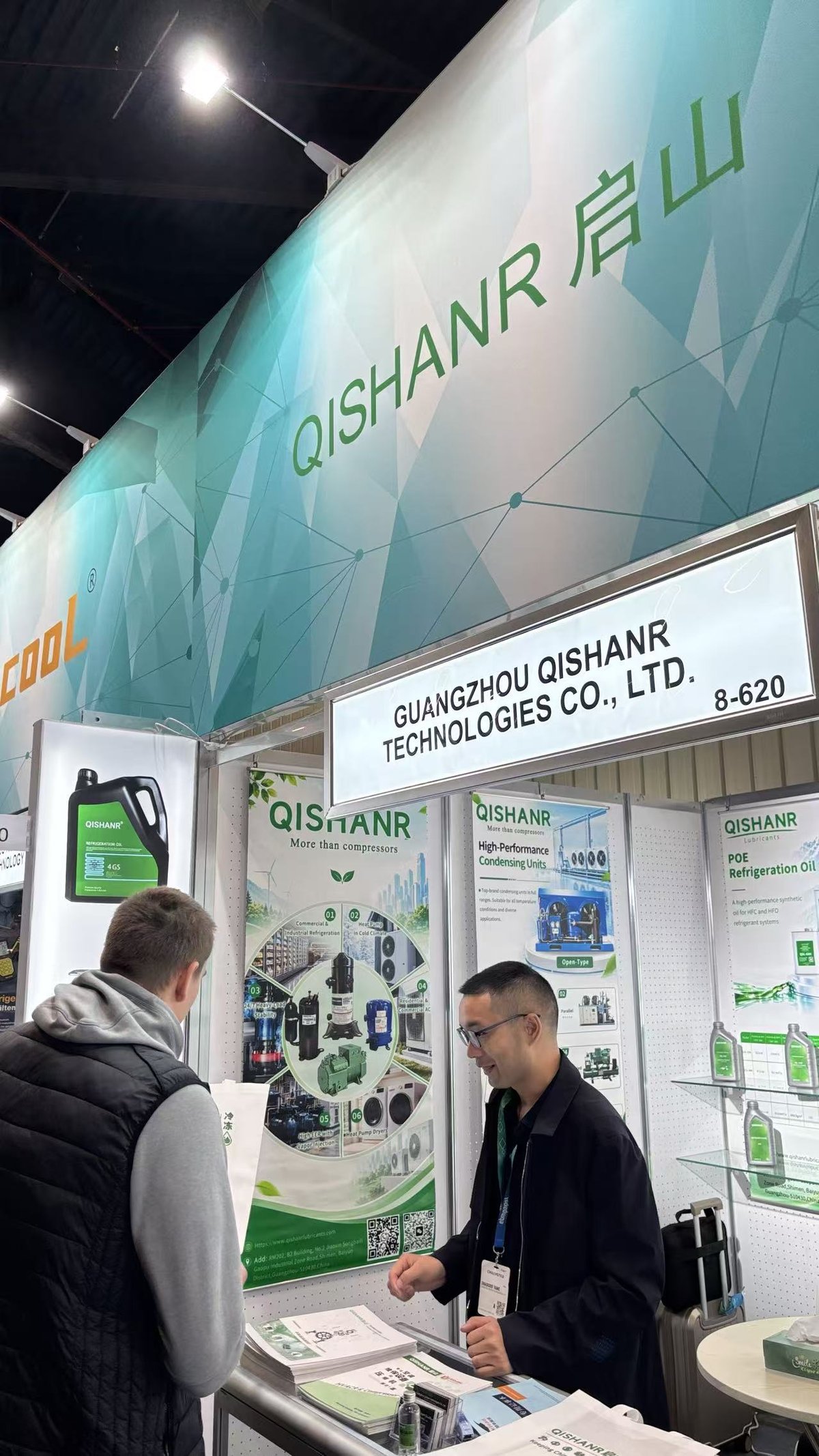 Qishanr team member introducing product brochures to a visitor