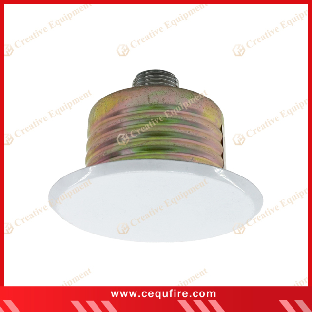 Concealed sprinkler head installed in ceiling, designed for automatic fire suppression with aesthetic cover plate