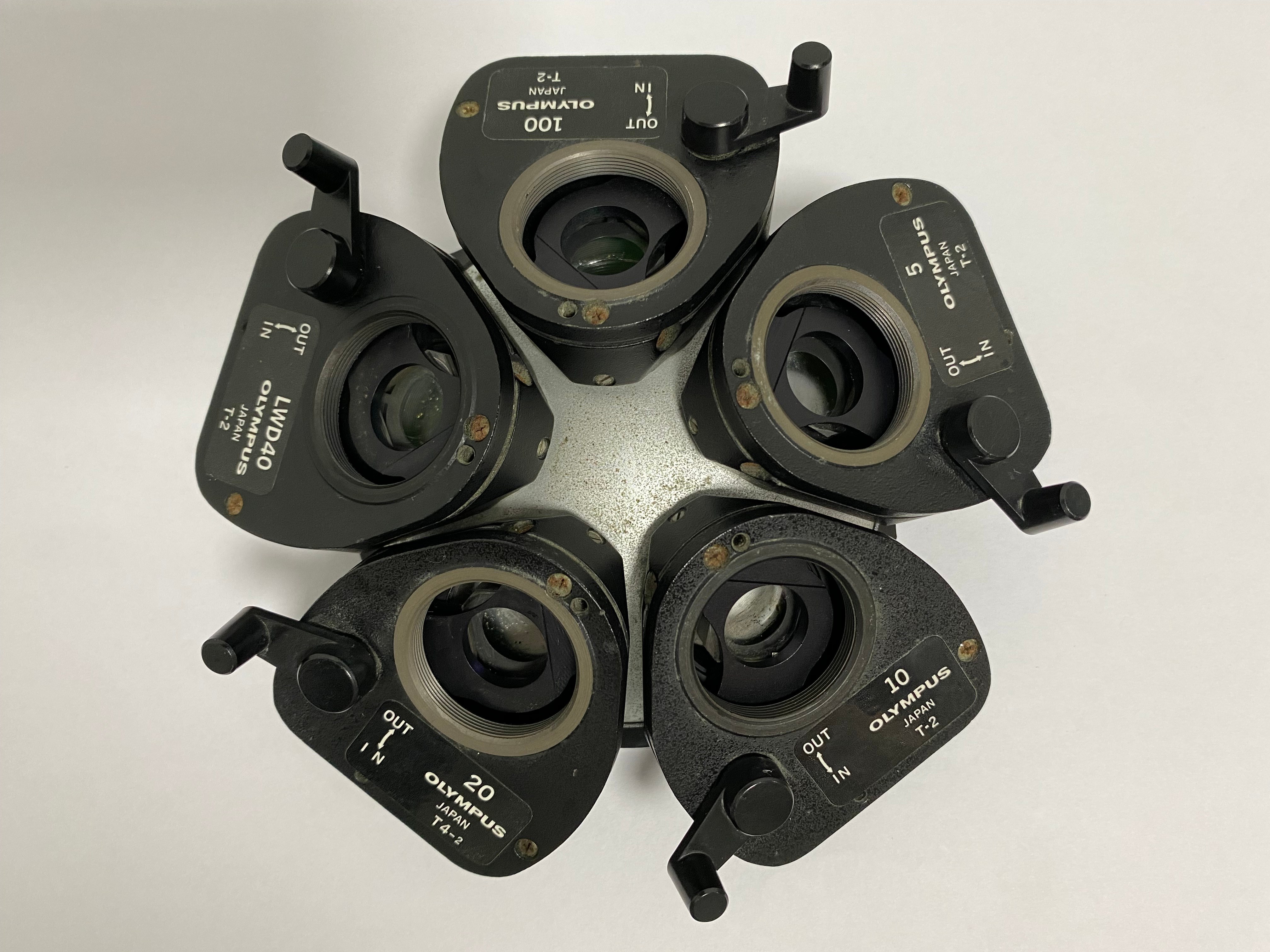 Used Olympus 5-position microscope nosepiece with DIC prisms set top view