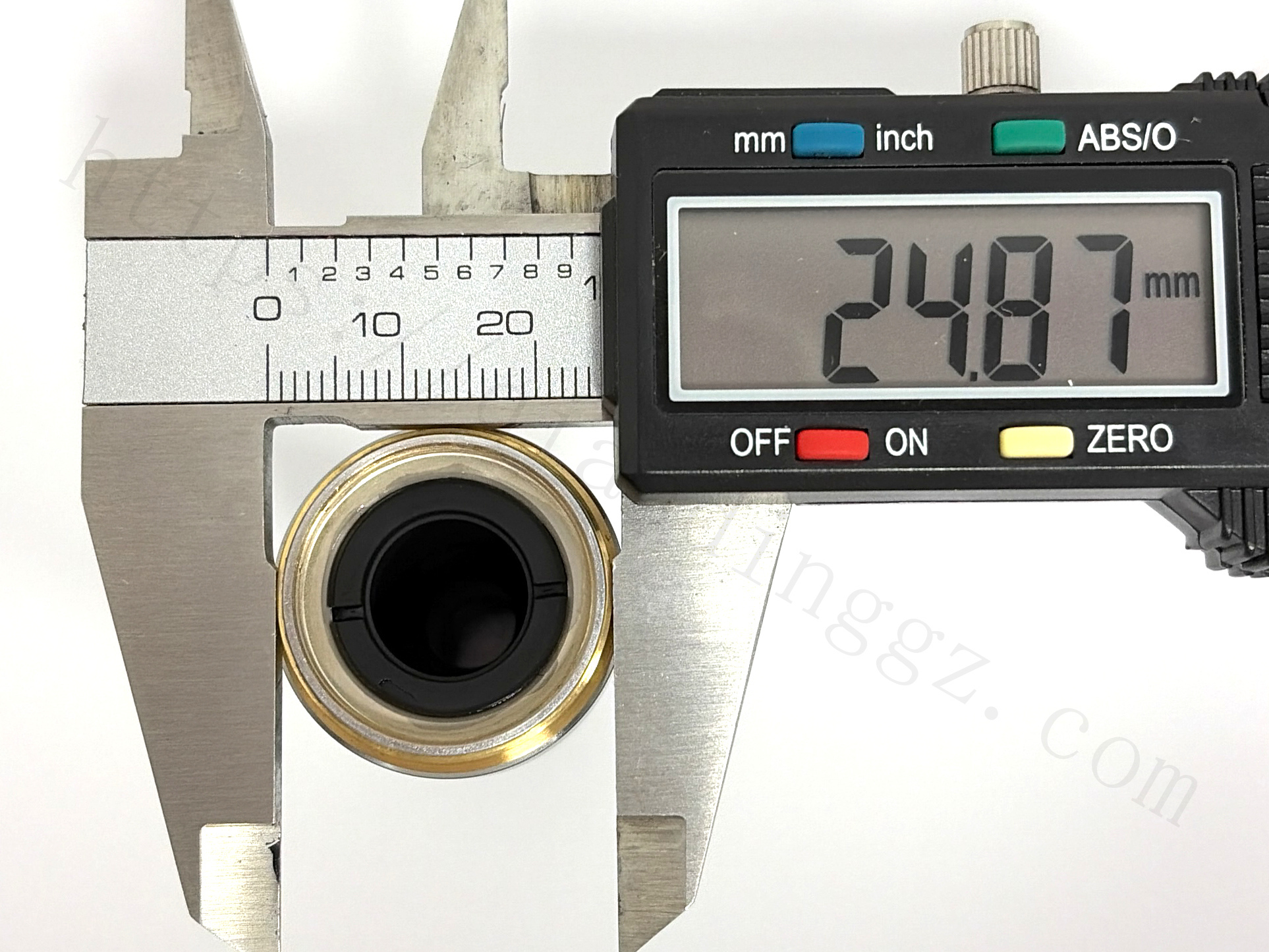 Measuring the thread diameter of Nikon 20X objective lens with digital caliper showing 24.87mm