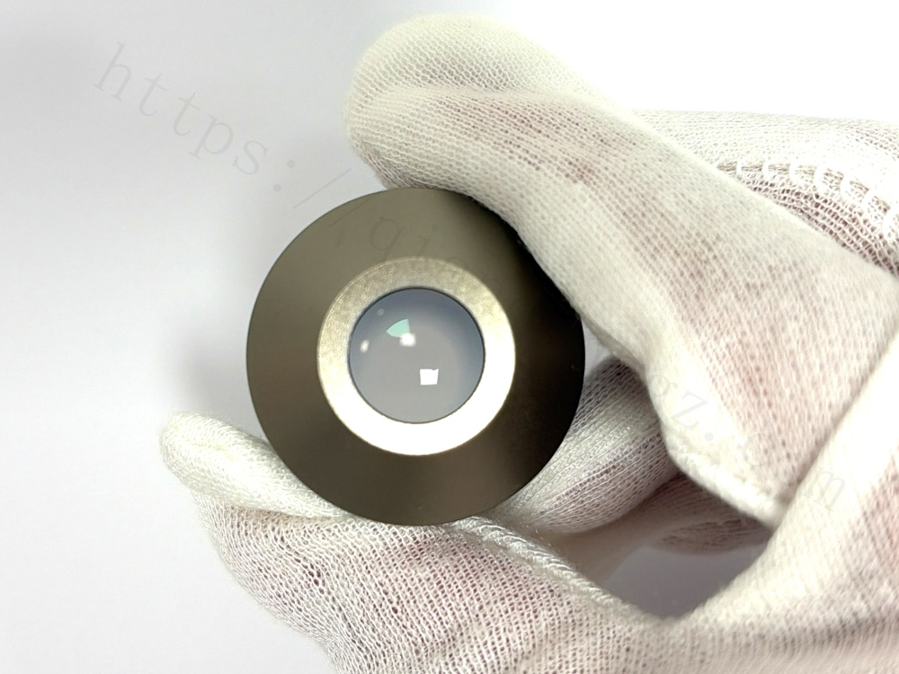 Close-up macro view of the front lens element on Nikon 4x PhL DL objective