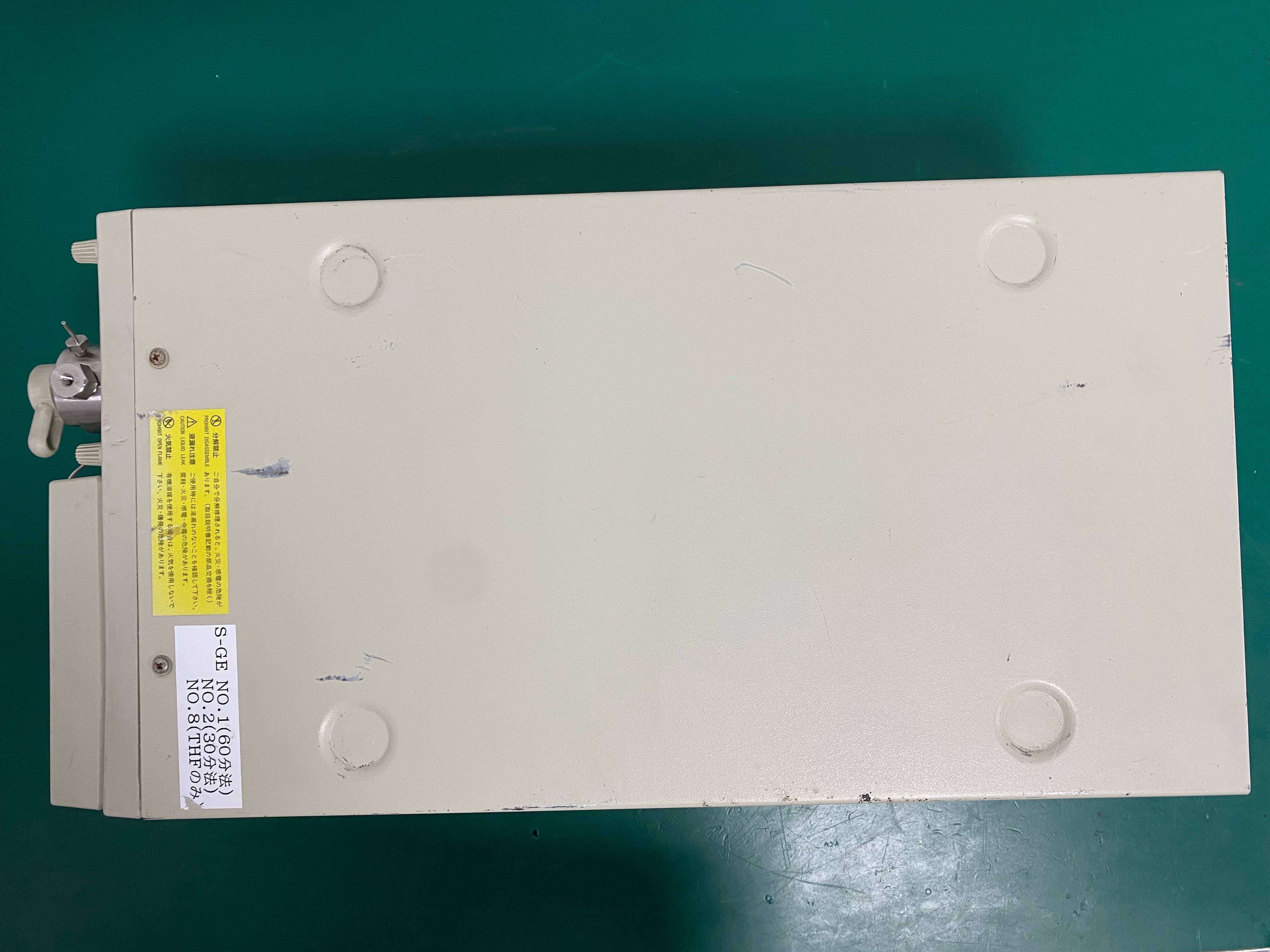 Top view of the outer casing of a pre-owned Tosoh DP-8020 lab pump with safety warning stickers