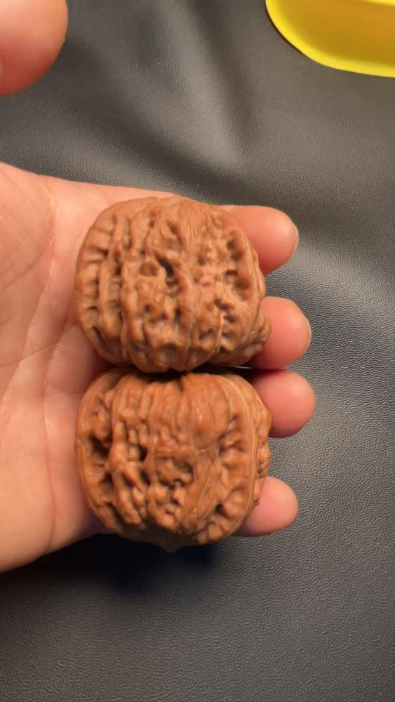 Hand-held walnuts, concave bottom, perfectly triangular shape, high-end and elegant, exquisite pair, red skin, mountain-grown fruit. A fine pair, perfect for personal enjoyment or as a gift.