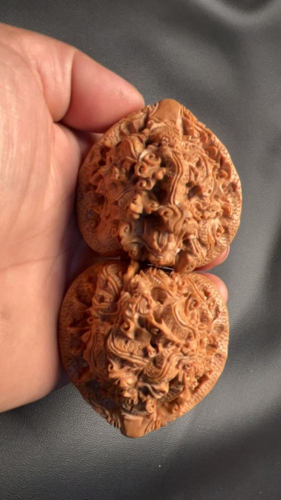 Hand-carved walnuts with nine dragons playing with a pearl, purely handmade, exquisite pair, from old tree fruit, a perfect gift, believed to help prevent Alzheimer's disease and promote health and wellness.