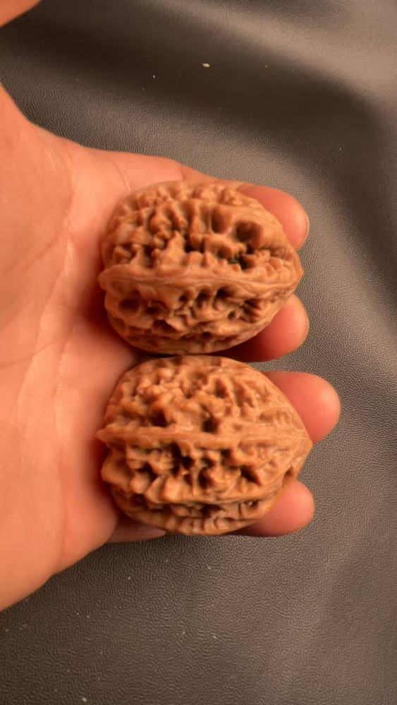 These are hand-carved walnuts with a thick, rugged texture, naturally grown, a fine pair, and top-quality skin.