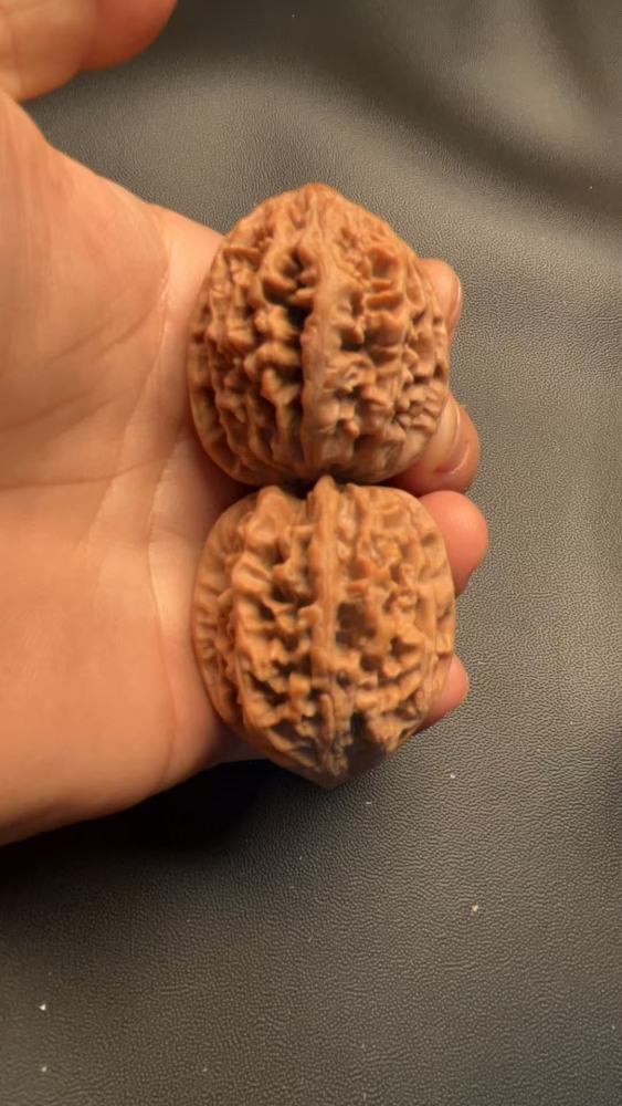 These are hand-carved walnuts with a thick, rugged texture, naturally grown, a fine pair, and top-quality skin.