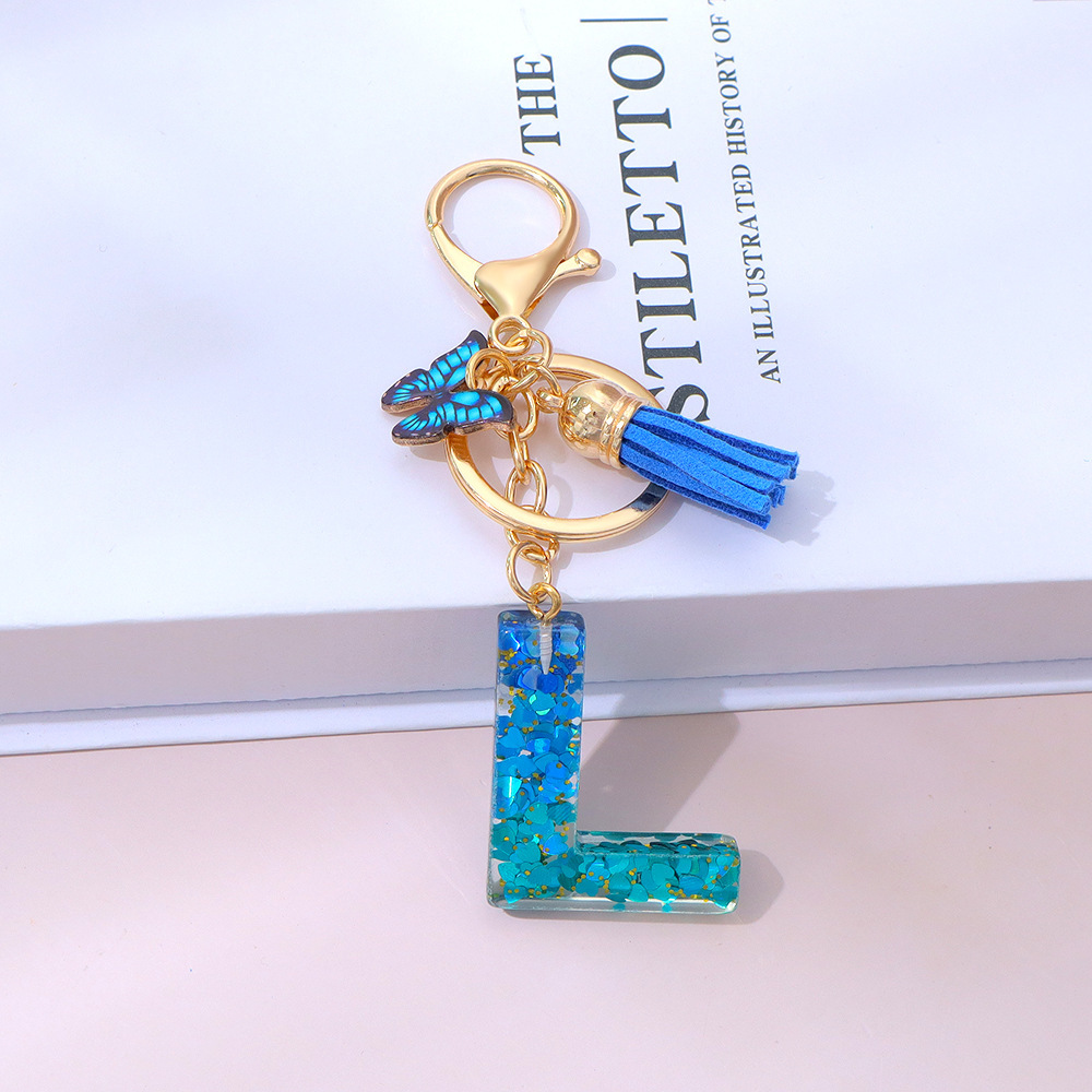 Wholesale blue gradient epoxy lettering, butterfly tassel pendants, women's bag charms, souvenirs.