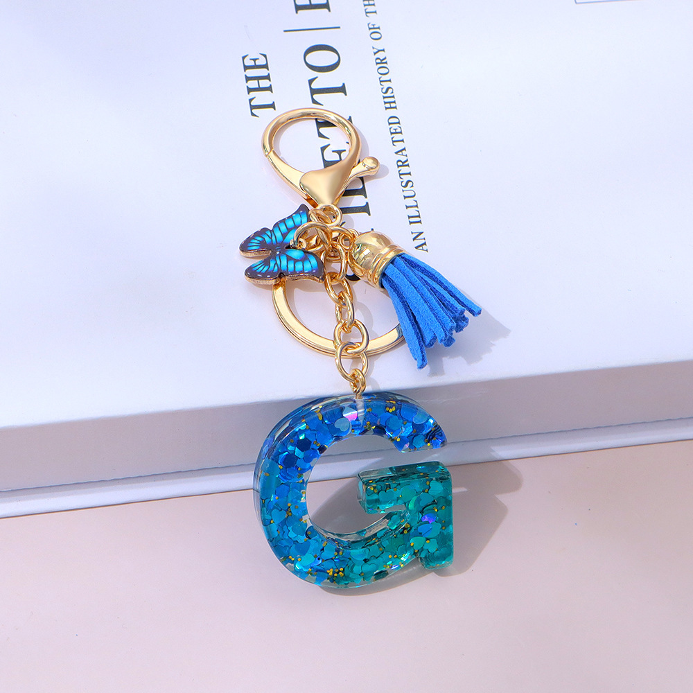 Wholesale blue gradient epoxy lettering, butterfly tassel pendants, women's bag charms, souvenirs.