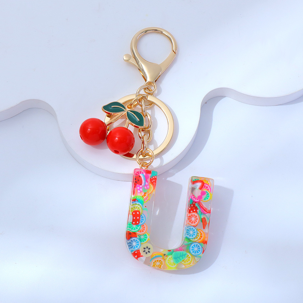 Wholesale fruit sequined letter keychains, resin tassel pendants, and women's bag charms.