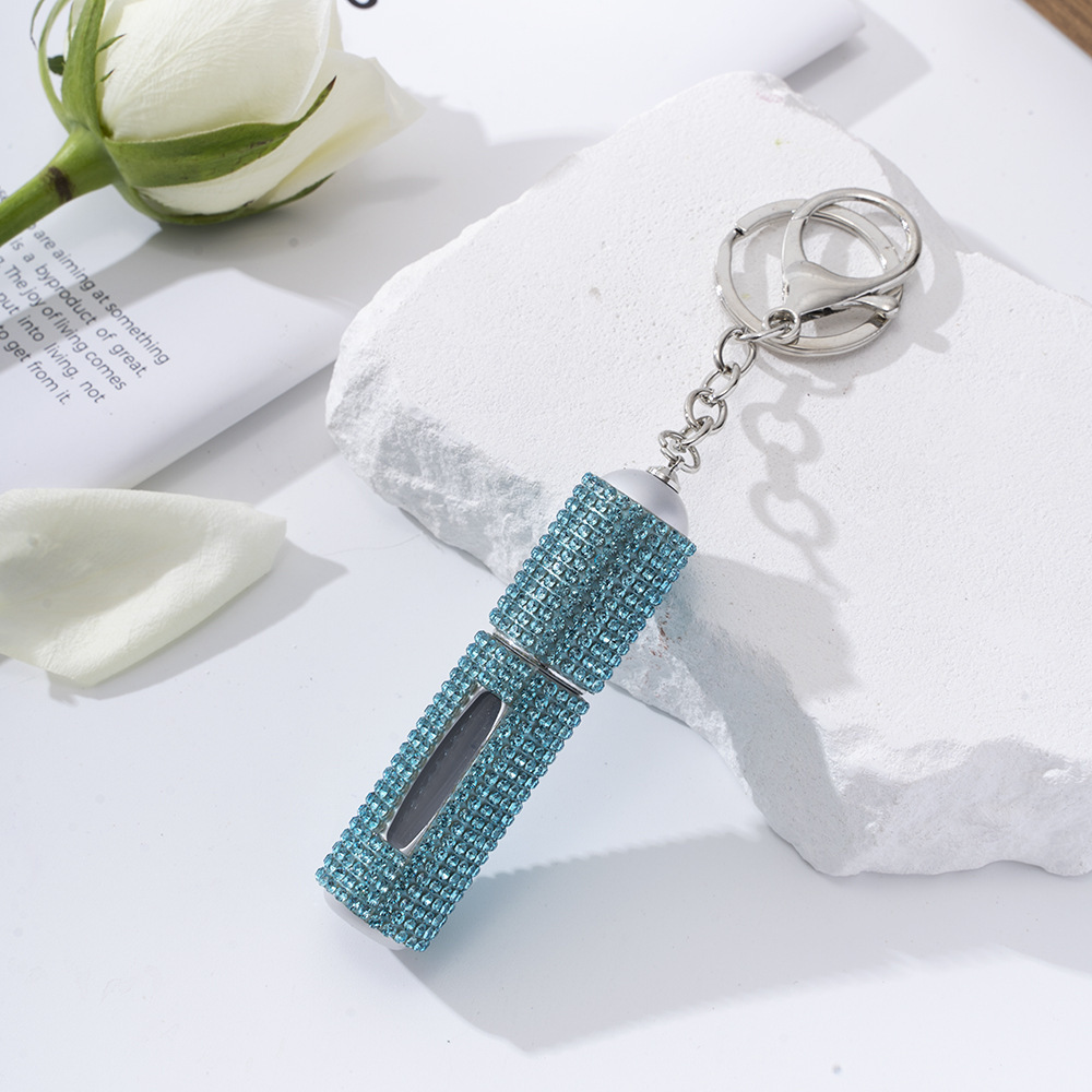Amazon's popular rhinestone-embellished creative perfume dispenser keychain for women—portable, exquisite, stylish, and convenient.