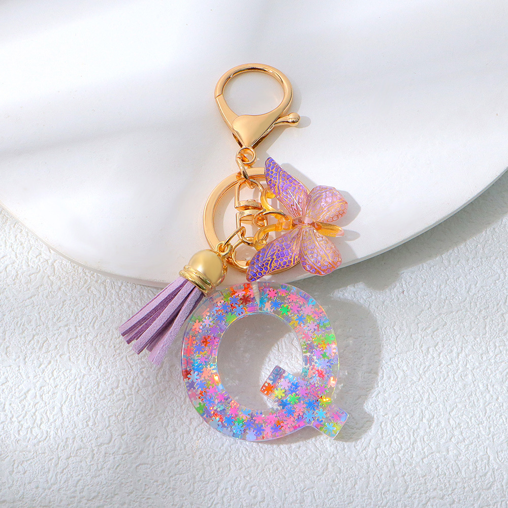 Wholesale purple snowflake sequined epoxy resin letter keychains, tassel butterfly pendants, decorations, and gifts.