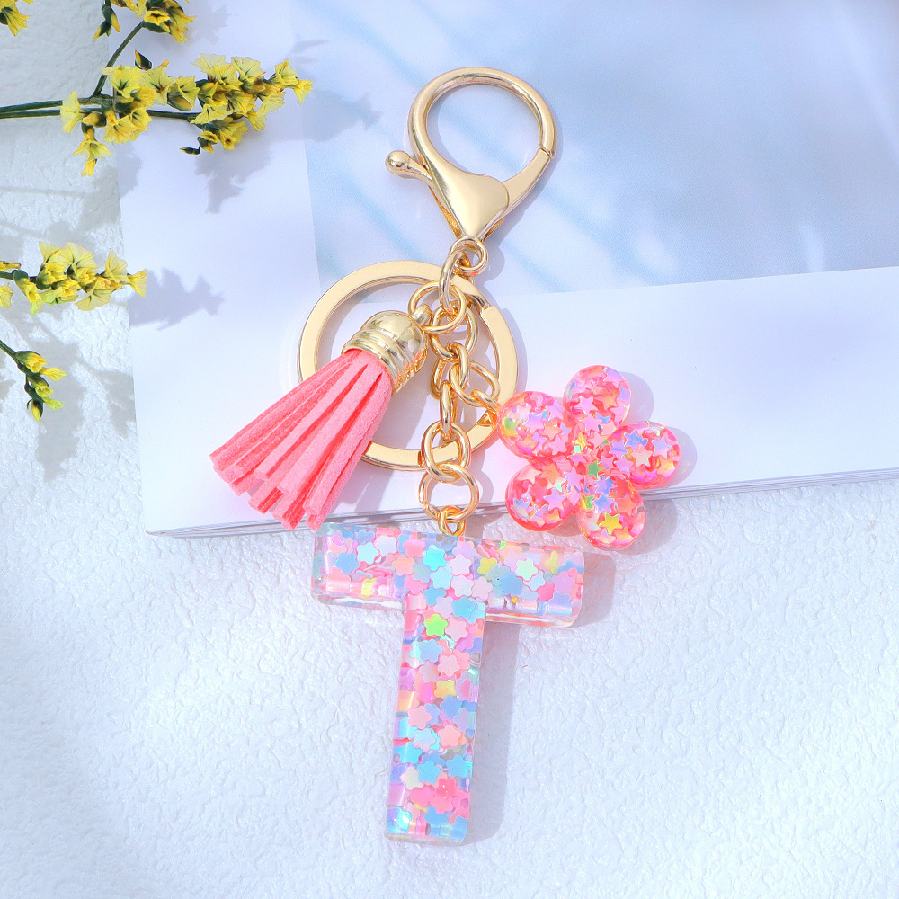 Wholesale pink star sequined epoxy resin letter keychains, flower pendants, DIY bag charms, perfect for gifting to your best friend.
