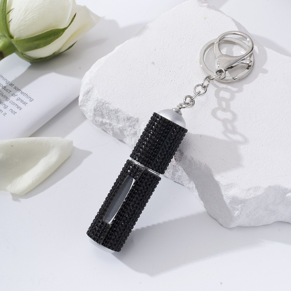 Amazon's popular rhinestone-embellished creative perfume dispenser keychain for women—portable, exquisite, stylish, and convenient.