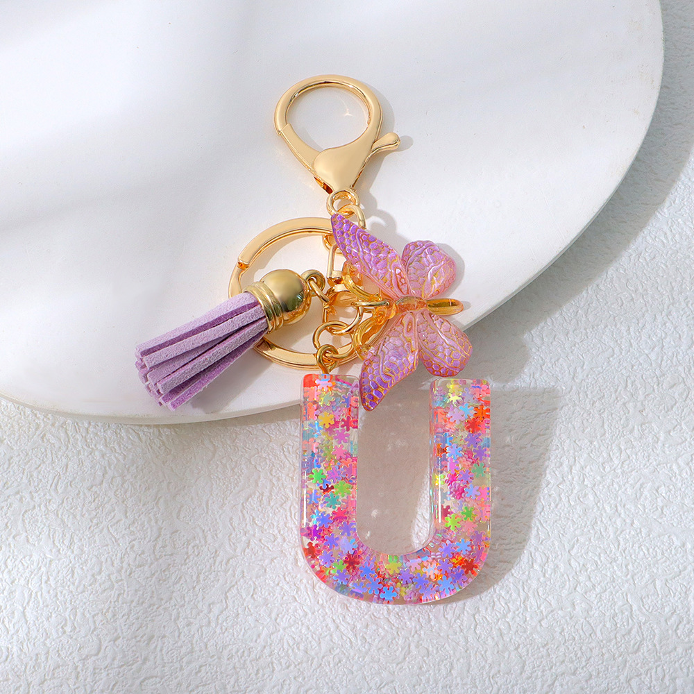 Wholesale purple snowflake sequined epoxy resin letter keychains, tassel butterfly pendants, decorations, and gifts.