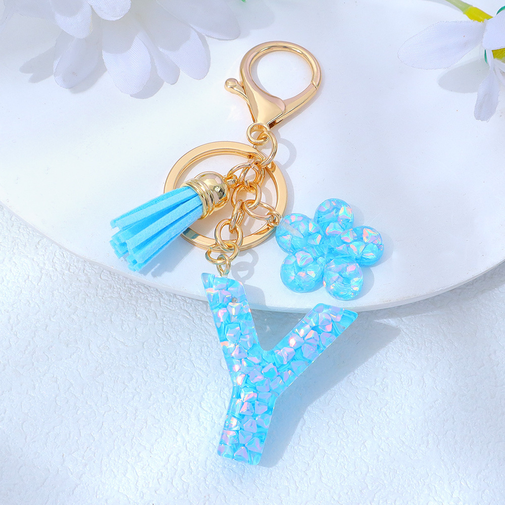 Wholesale blue crystal epoxy letter keychains, letter pendants, flower charms, and bag decorations.