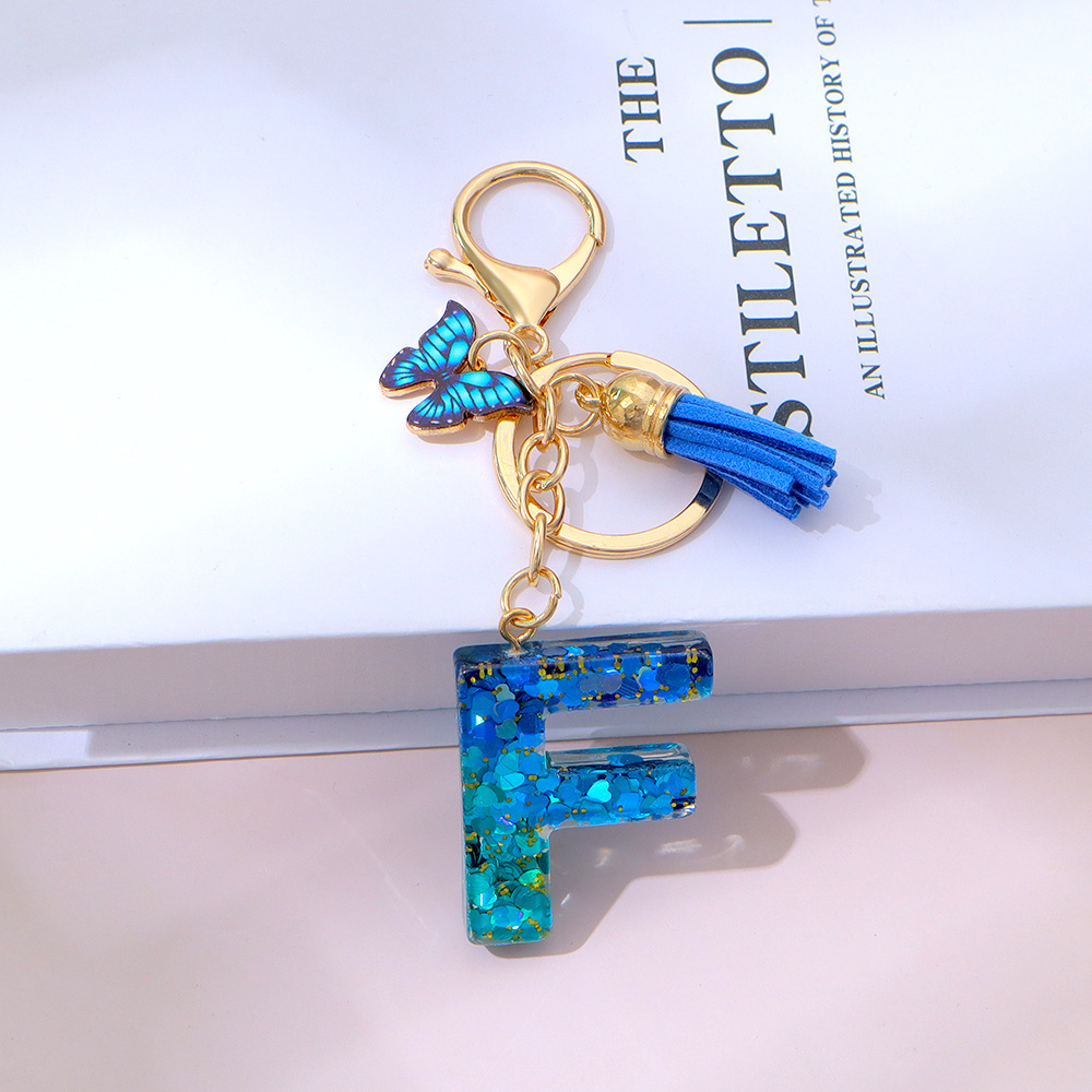 Wholesale blue gradient epoxy lettering, butterfly tassel pendants, women's bag charms, souvenirs.
