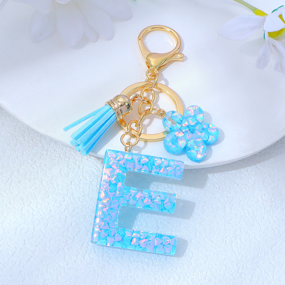 Wholesale blue crystal epoxy letter keychains, letter pendants, flower charms, and bag decorations.