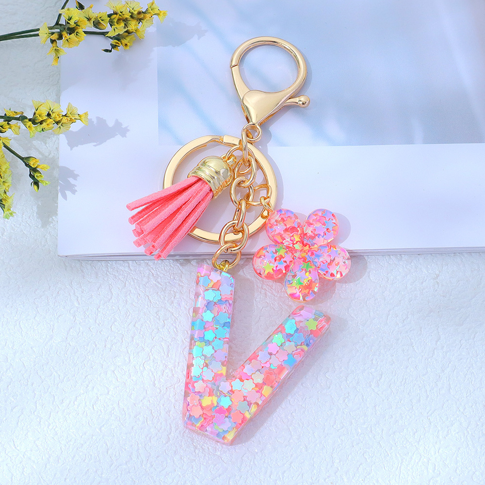 Wholesale pink star sequined epoxy resin letter keychains, flower pendants, DIY bag charms, perfect for gifting to your best friend.