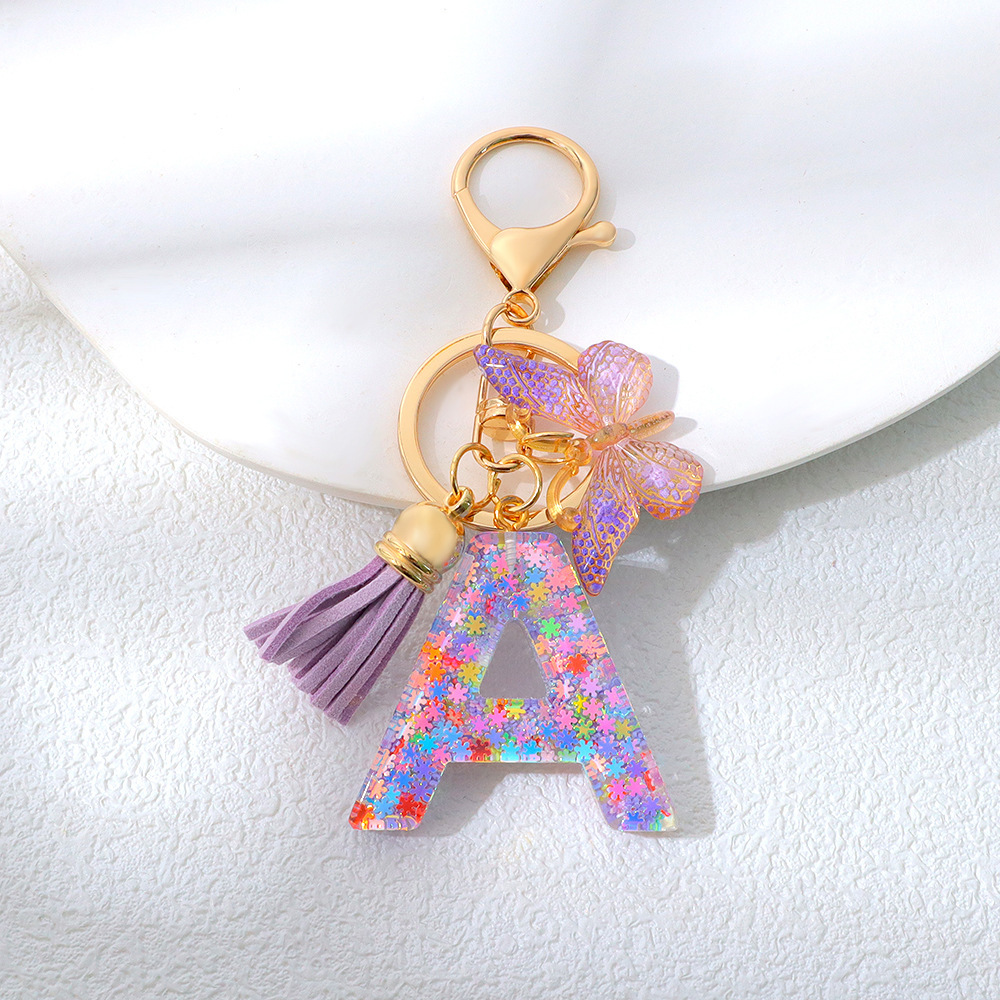Wholesale purple snowflake sequined epoxy resin letter keychains, tassel butterfly pendants, decorations, and gifts.
