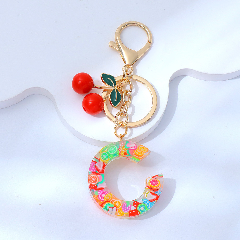 Wholesale fruit sequined letter keychains, resin tassel pendants, and women's bag charms.
