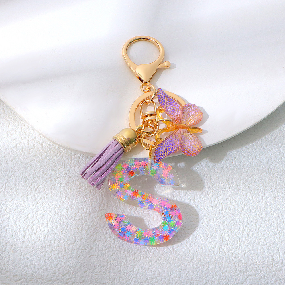 Wholesale purple snowflake sequined epoxy resin letter keychains, tassel butterfly pendants, decorations, and gifts.