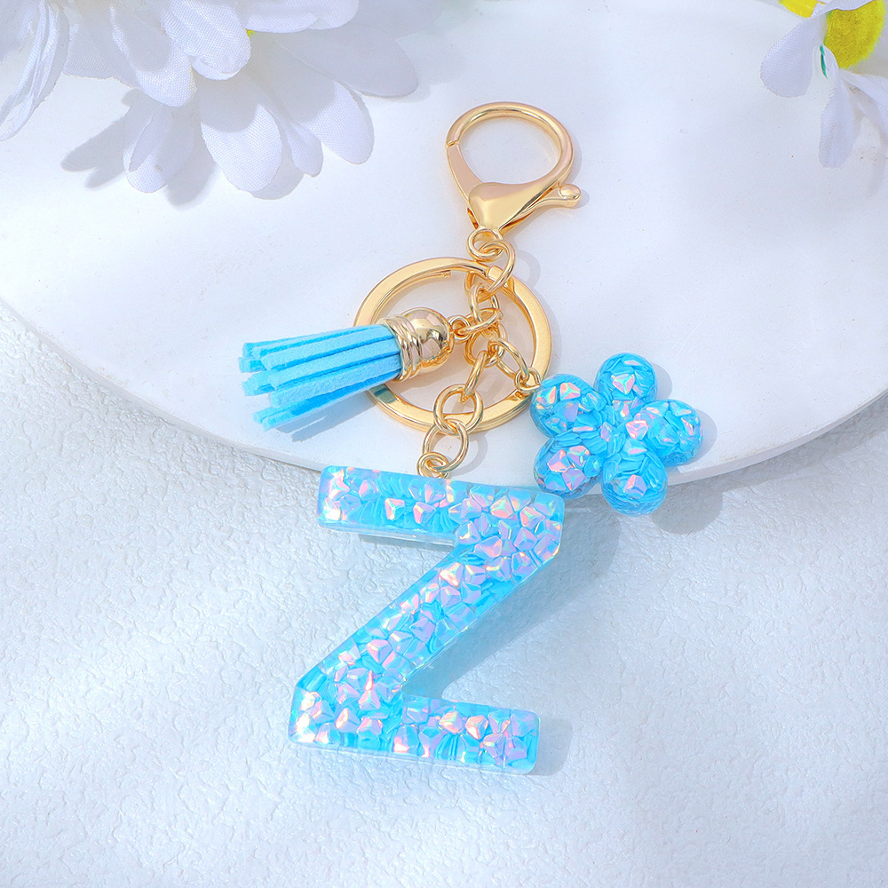 Wholesale blue crystal epoxy letter keychains, letter pendants, flower charms, and bag decorations.