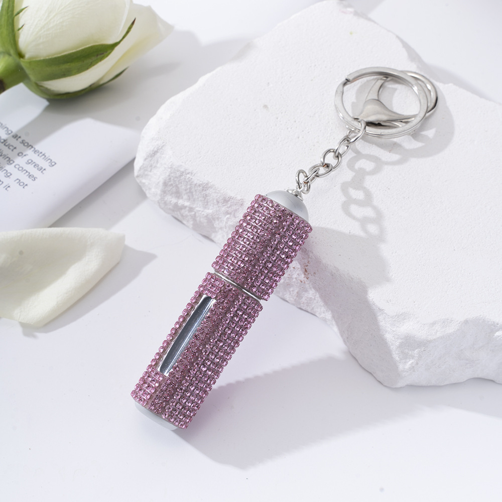 Amazon's popular rhinestone-embellished creative perfume dispenser keychain for women—portable, exquisite, stylish, and convenient.