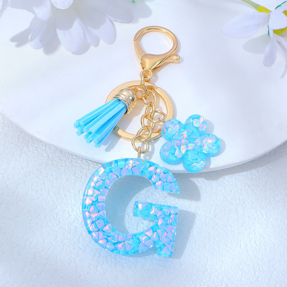 Wholesale blue crystal epoxy letter keychains, letter pendants, flower charms, and bag decorations.