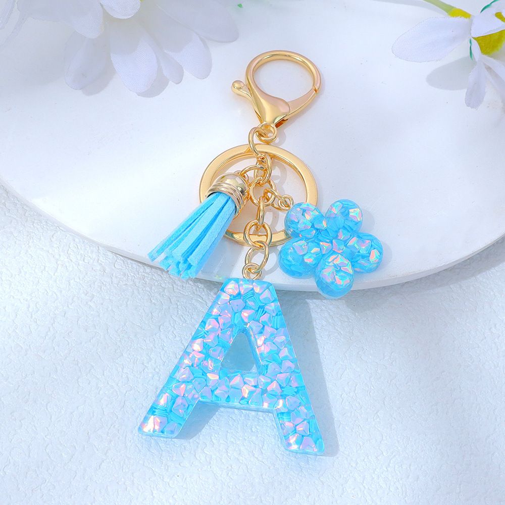 Wholesale blue crystal epoxy letter keychains, letter pendants, flower charms, and bag decorations.