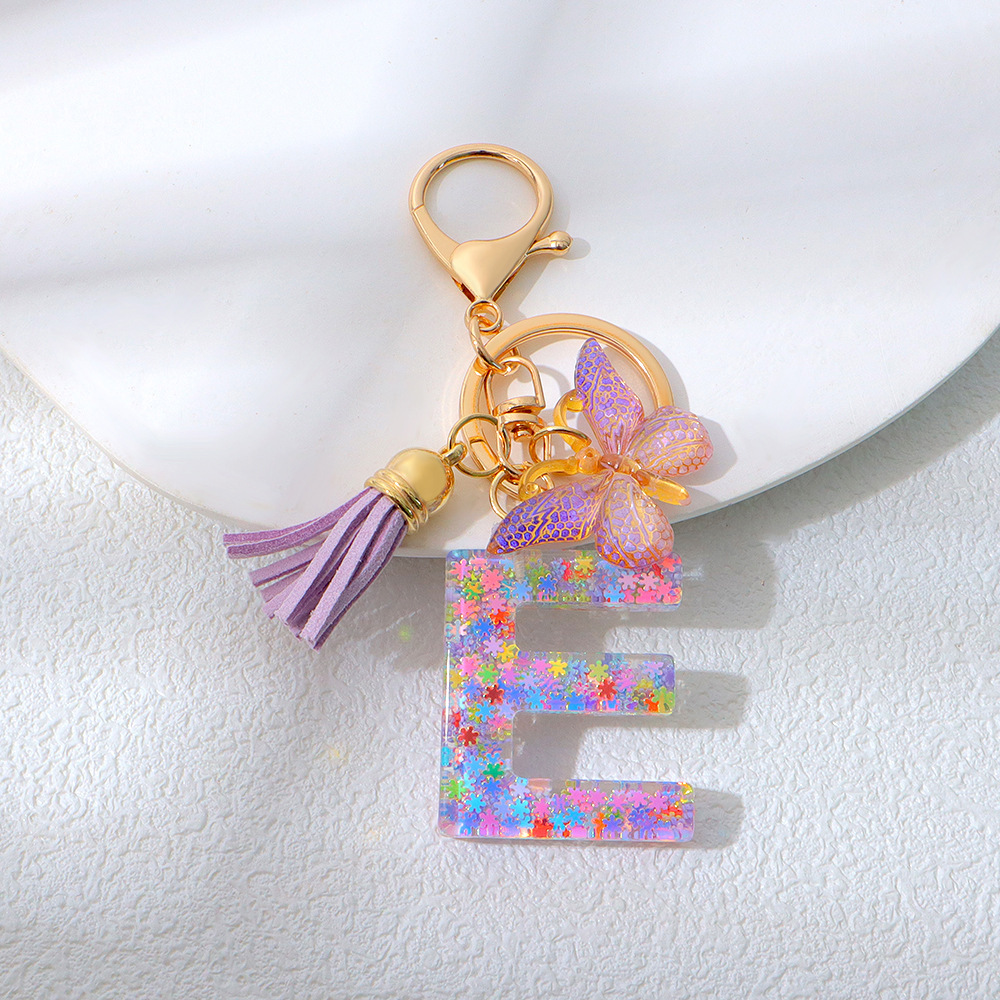 Wholesale purple snowflake sequined epoxy resin letter keychains, tassel butterfly pendants, decorations, and gifts.