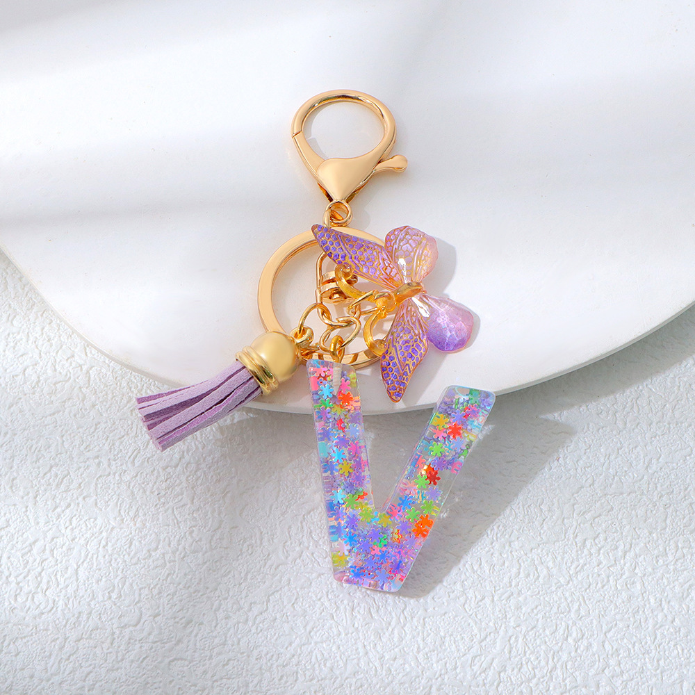 Wholesale purple snowflake sequined epoxy resin letter keychains, tassel butterfly pendants, decorations, and gifts.
