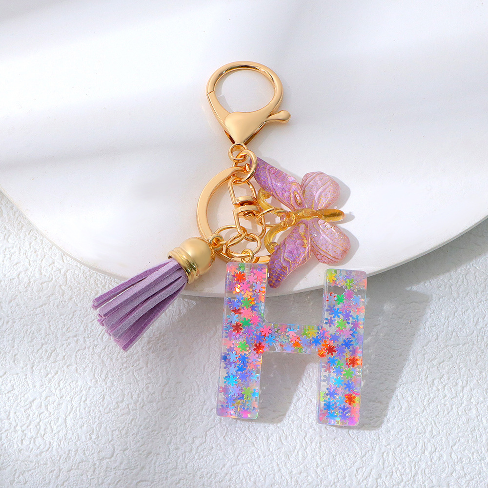 Wholesale purple snowflake sequined epoxy resin letter keychains, tassel butterfly pendants, decorations, and gifts.
