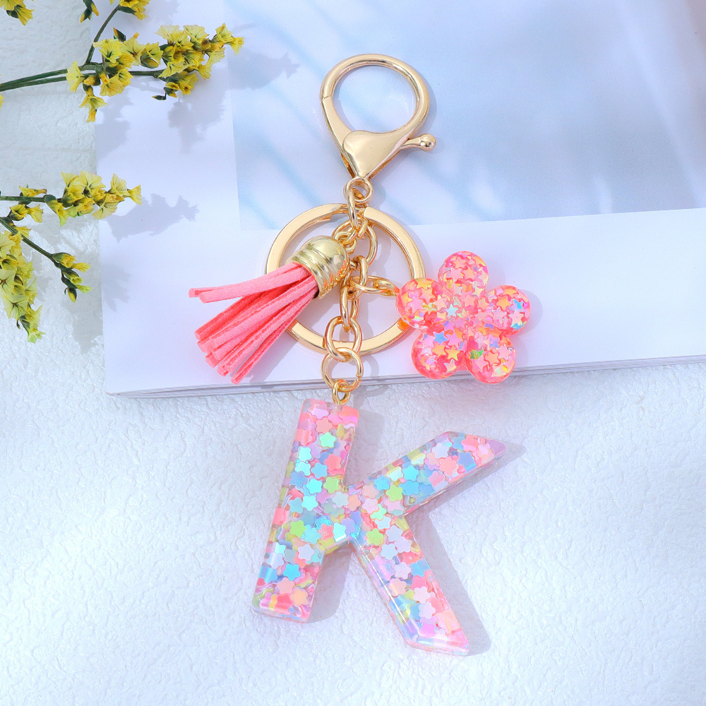 Wholesale pink star sequined epoxy resin letter keychains, flower pendants, DIY bag charms, perfect for gifting to your best friend.